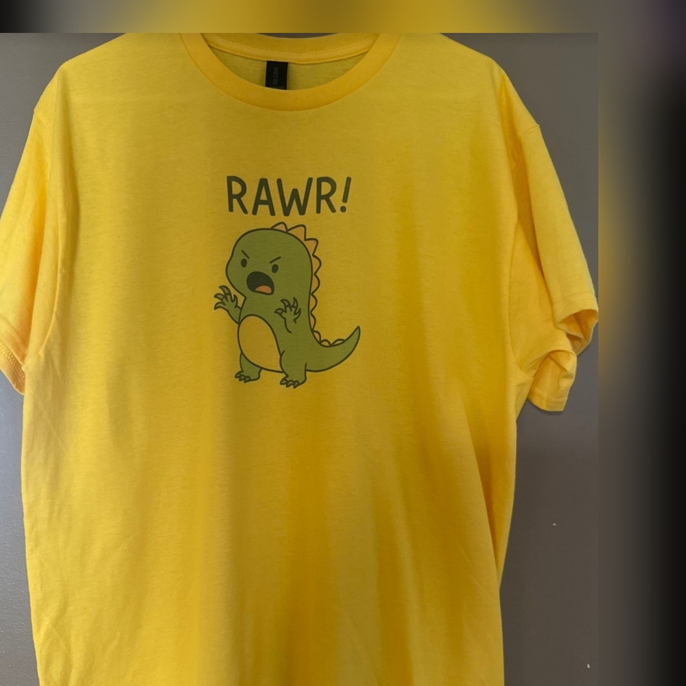 🦖Get your dino on with this adorable yellow t-shirt! Featuring cute green dinos